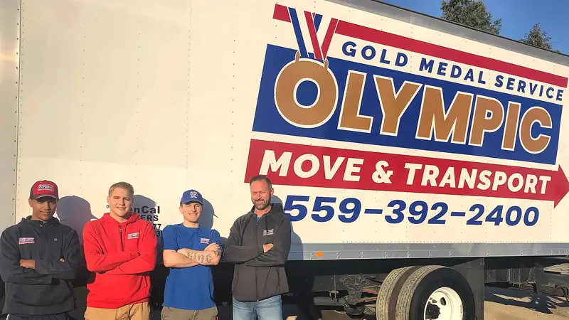 Olympic Move & Transport crew in front of the moving truck