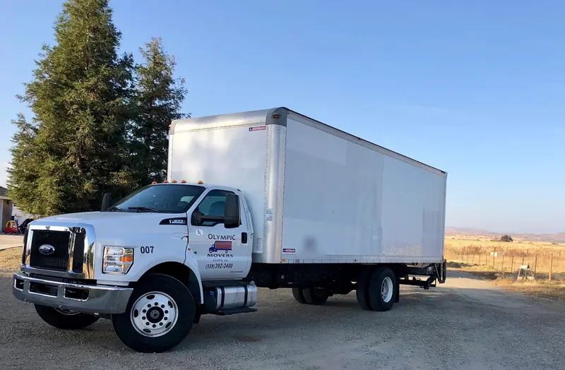 White Olympic box truck on a rural Central Valley road